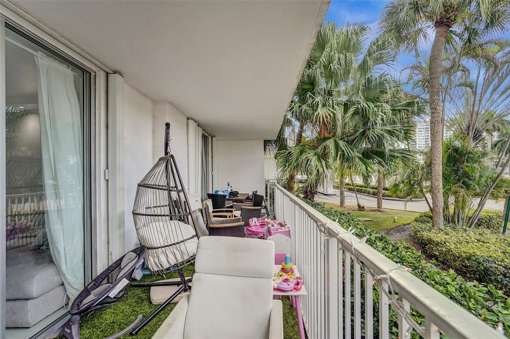 2801 Northeast 183rd Street, Unit 101W Aventura, FL 33160 - Photo 34 of 39 a balcony with chairs and wooden floor