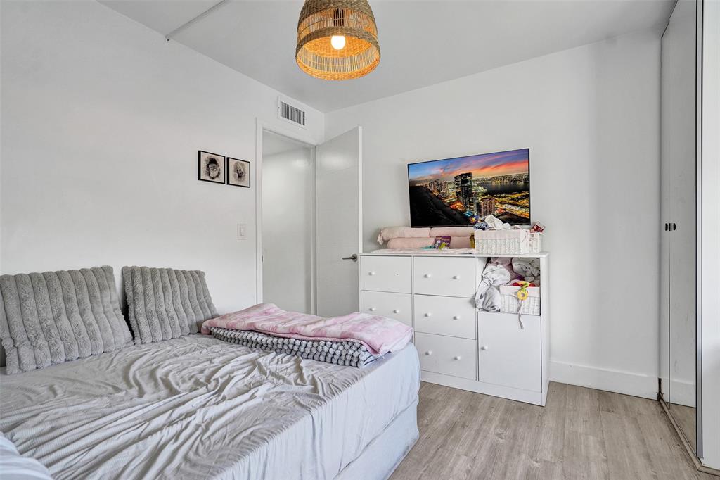 2801 Northeast 183rd Street, Unit 101W Aventura, FL 33160 - Photo 7 of 39 a bedroom with a bed and flat screen tv