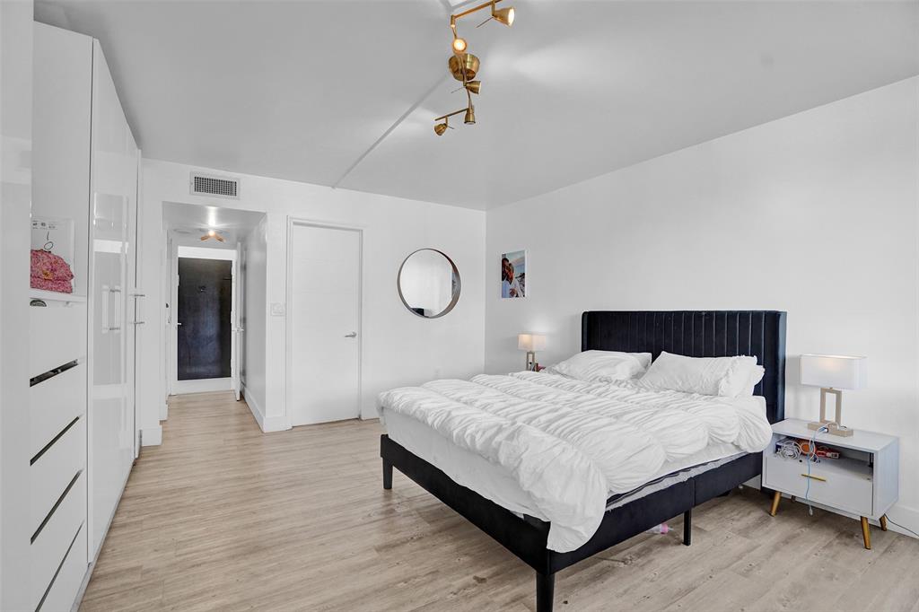 2801 Northeast 183rd Street, Unit 101W Aventura, FL 33160 - Photo 9 of 39 a bedroom with a bed and wooden floor