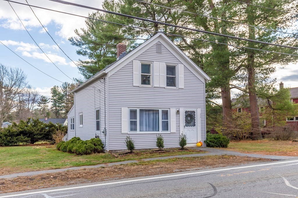 373 Andover Road Billerica, MA 01821 - Photo 1 of 23 a view of a house with a yard and large tree and plants