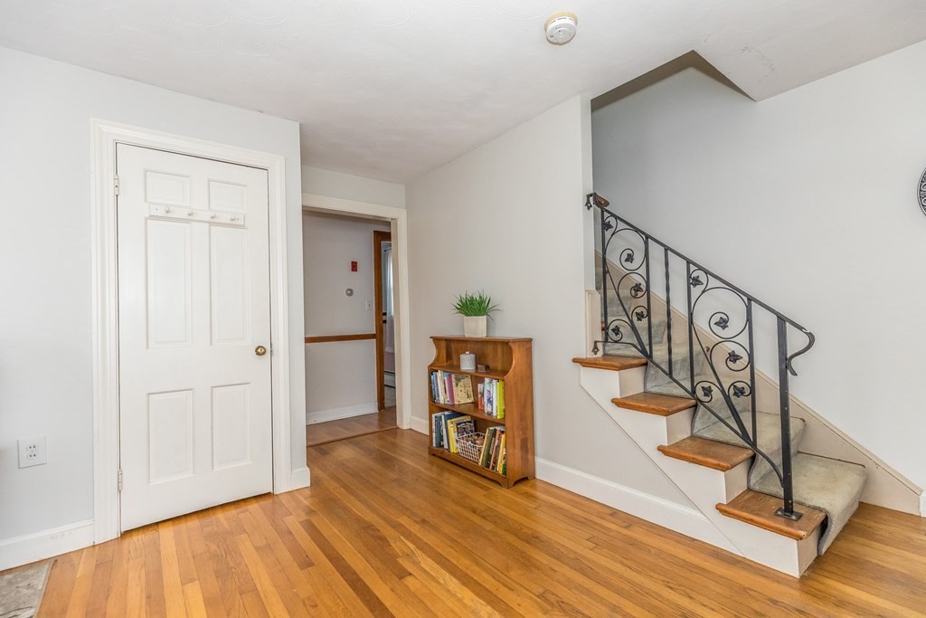 373 Andover Road Billerica, MA 01821 - Photo 6 of 23 a view of a livingroom with wooden floor and stairs