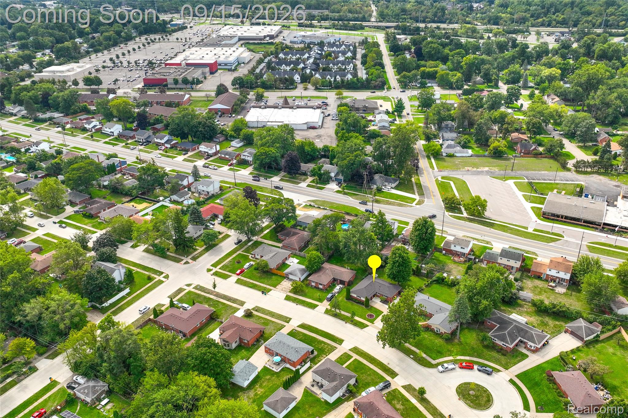 22947 Tuck Road Farmington, MI 48336 - Photo 33 of 34 Aerial perspective showcasing a residential neighborhood with mature trees and a nearby commercial district