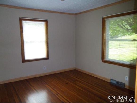 2078 Murray Road Canton, NC 28716 - Photo 13 of 20 a view of an empty room with wooden floor and a window