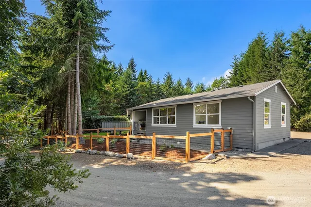 a view of a house with backyard porch and sitting area