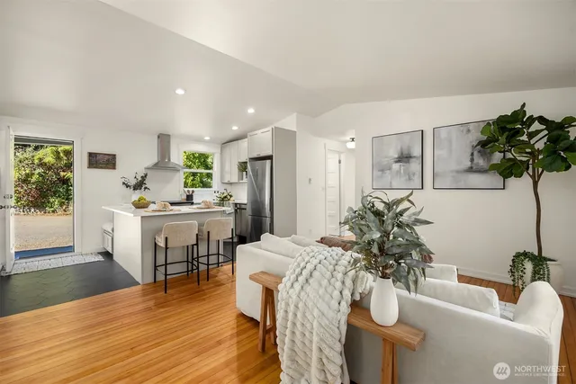 a living room with furniture and a potted plant