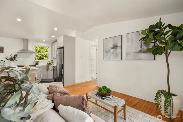 a living room with furniture flowers and a chandelier