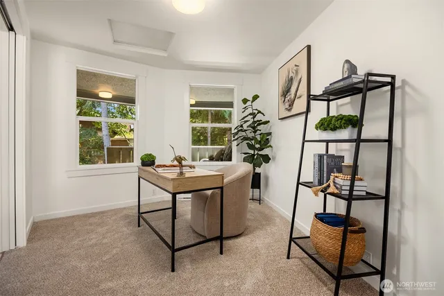a view of a livingroom with furniture and a potted plant