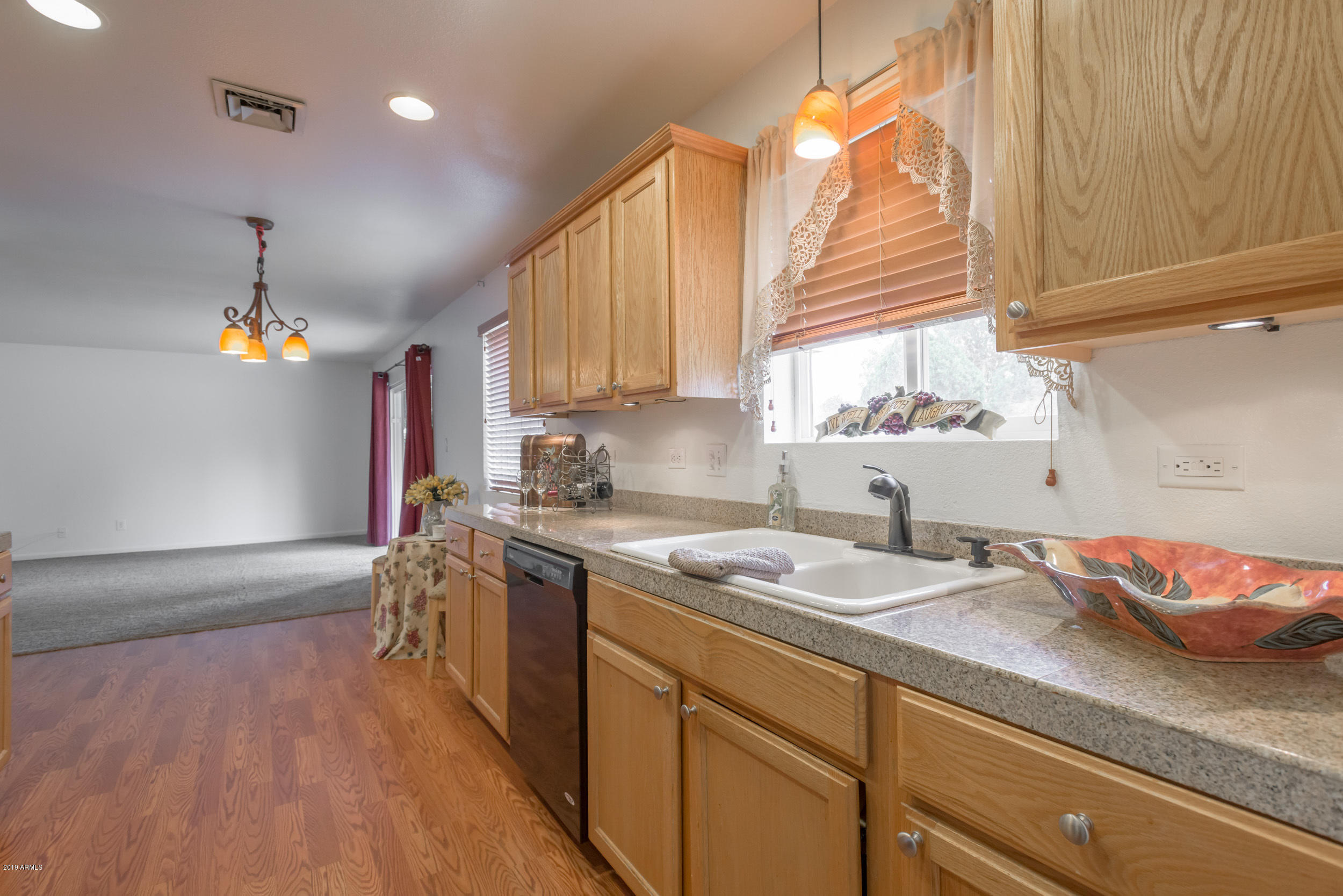 3517 South Terrace Road Tempe, AZ 85282 - Photo 1 of 31 a kitchen with stainless steel appliances granite countertop a sink a stove and a wooden floor