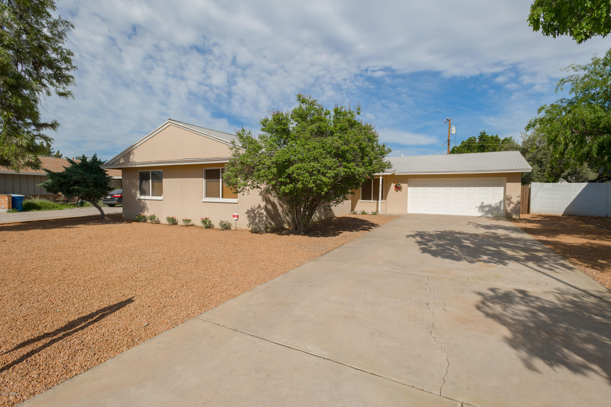 3517 South Terrace Road Tempe, AZ 85282 - Photo 3 of 31 a front view of a house with a yard and garage