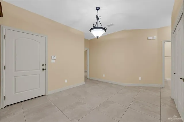 a view of an empty room with a chandelier