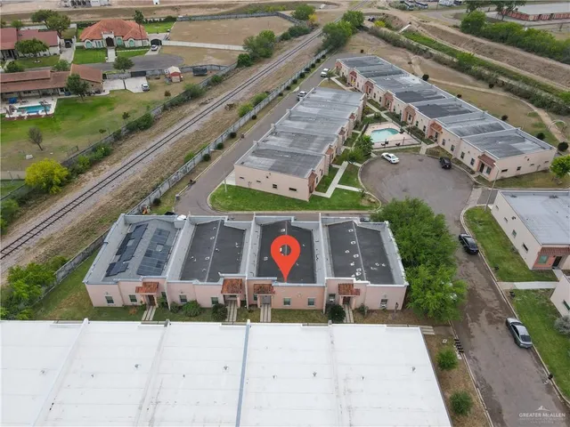 an aerial view of a house with a yard