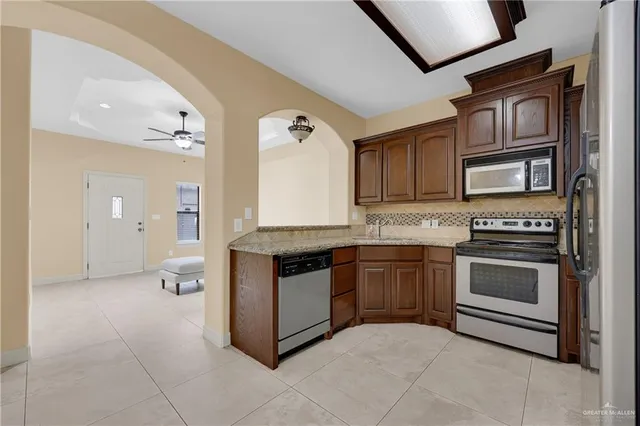 a kitchen with stainless steel appliances granite countertop a stove and a sink