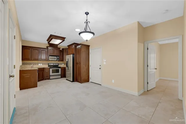 a open kitchen with cabinets a sink and stainless steel appliances