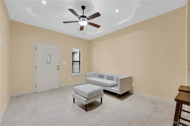 a living room with furniture and a ceiling fan