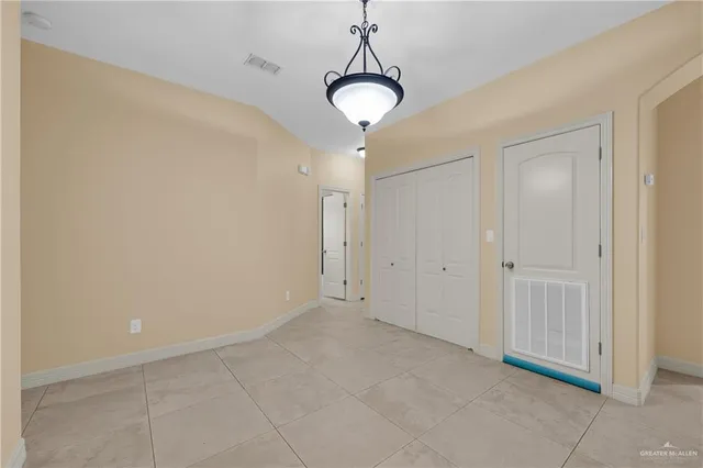 a view of a chandelier fan and entryway