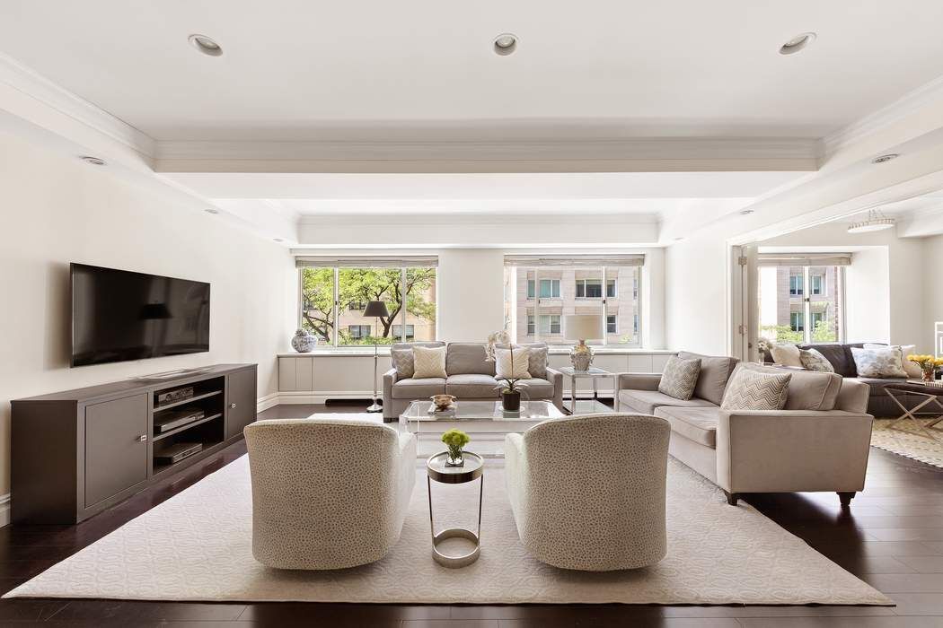 a living room with fireplace furniture and a flat screen tv