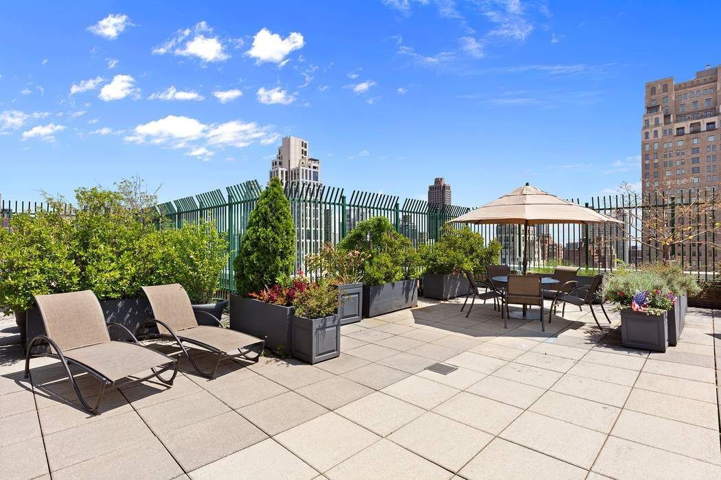 201 East 80th Street, Unit 3D Manhattan, NY 10075 - Photo 14 of 16 a view of a patio with a table and chairs and potted plants