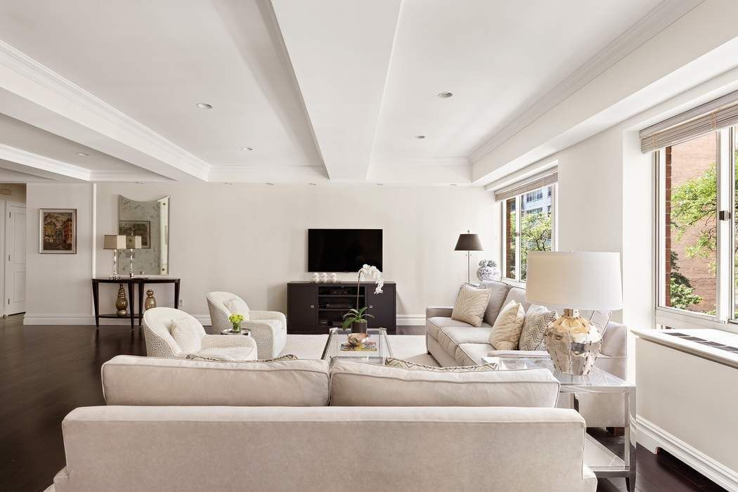 201 East 80th Street, Unit 3D Manhattan, NY 10075 - Photo 2 of 16 a living room with furniture and a flat screen tv