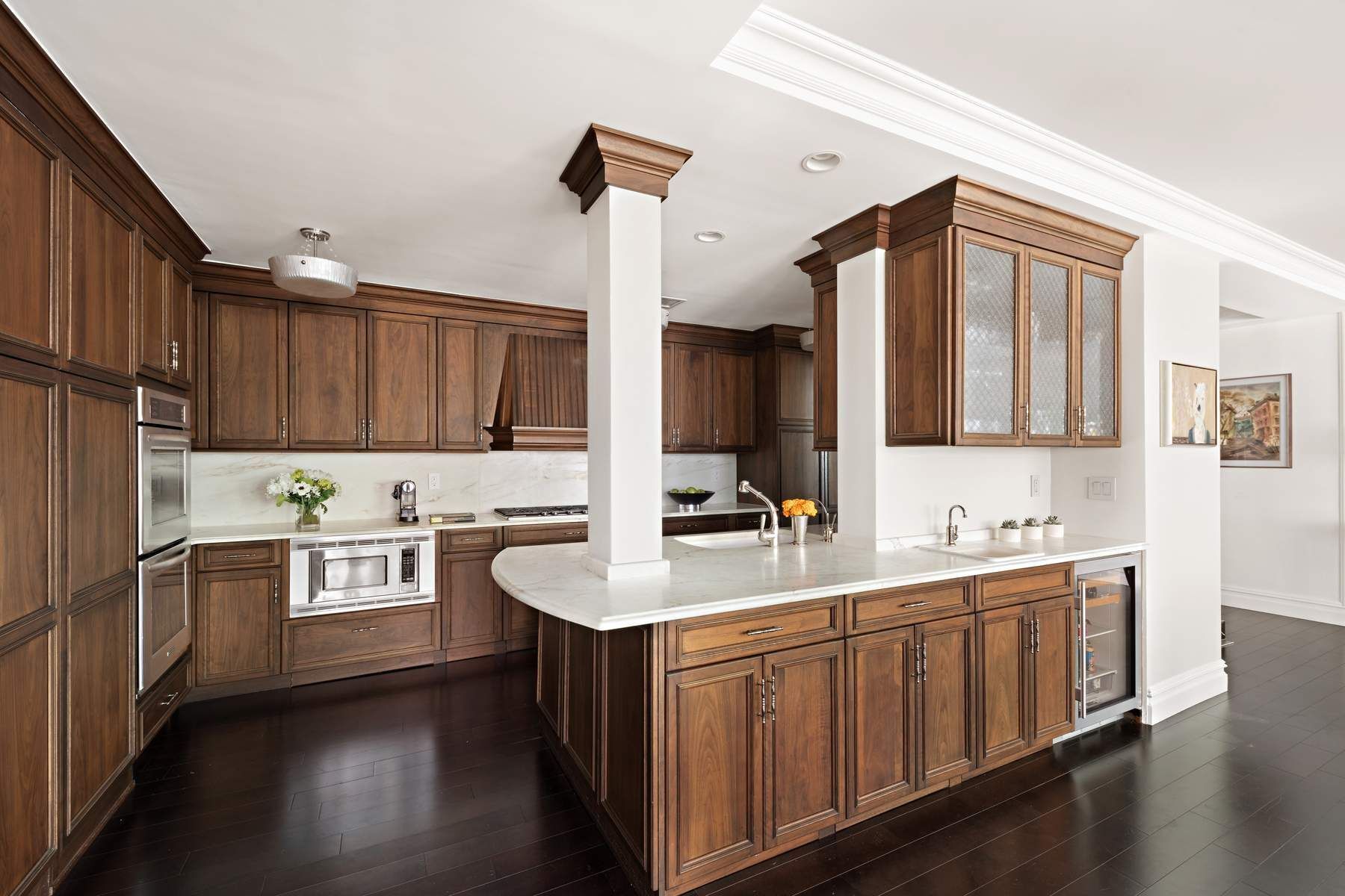 201 East 80th Street, Unit 3D Manhattan, NY 10075 - Photo 6 of 16 a kitchen with stainless steel appliances a sink stove and cabinets