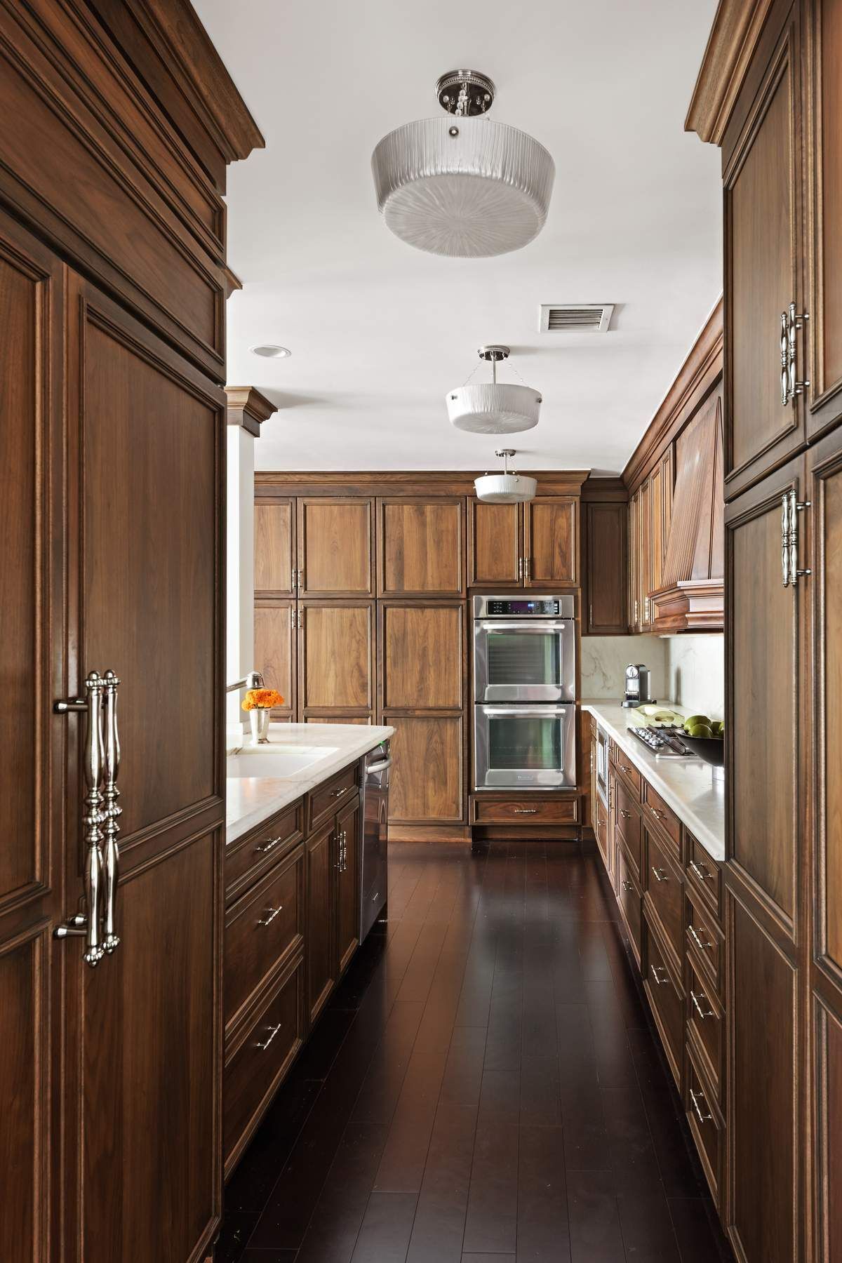201 East 80th Street, Unit 3D Manhattan, NY 10075 - Photo 8 of 16 a kitchen with kitchen island a sink appliances and cabinets