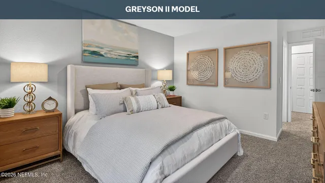 a bedroom with a bed and painting on the wall