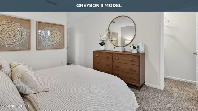 a bedroom with a bed and a dresser