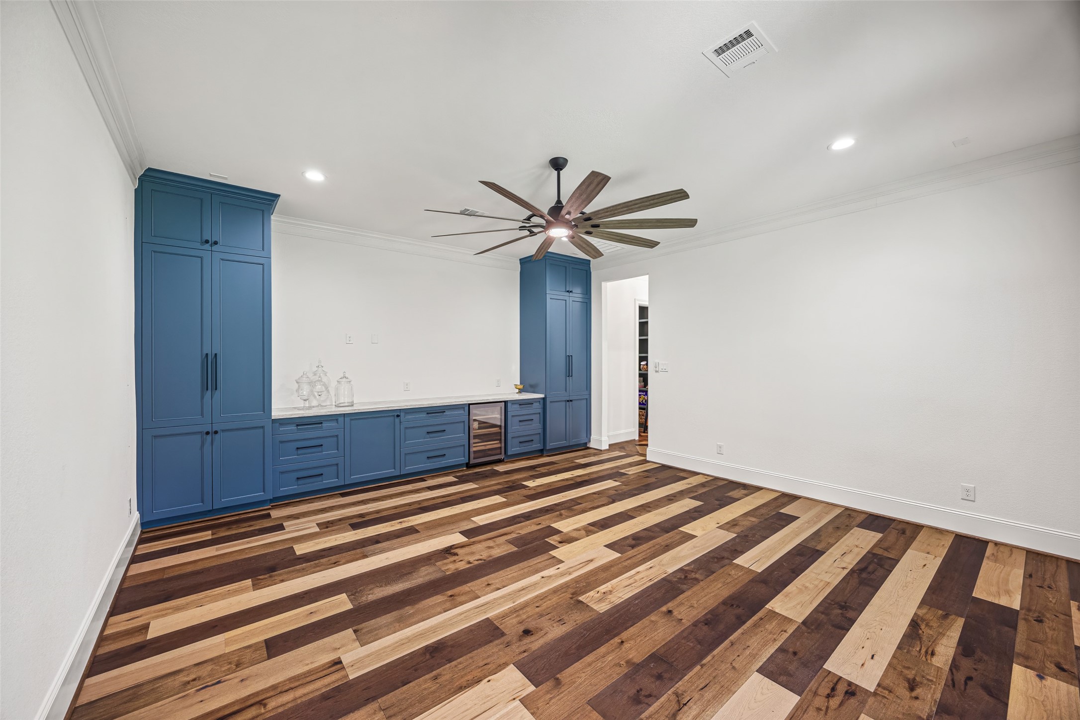 19314 Chateau Ridge Court Tomball, TX 77377 - Photo 37 of 50 Downstairs entertainment space complete with a sleek built-in and wine fridge, ideal for gatherings, game nights, or casual lounging.