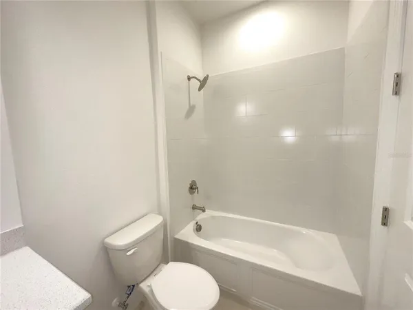 a bathroom with a toilet and a bathtub