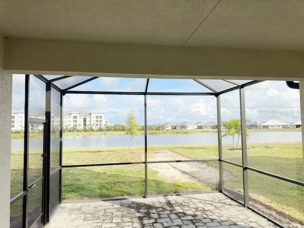 a view of a glass door with a big yard