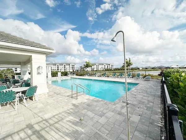 a swimming pool with outdoor seating and plants