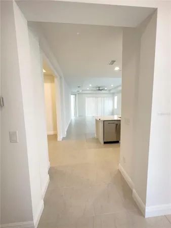 a view of a big room with wooden floor and windows