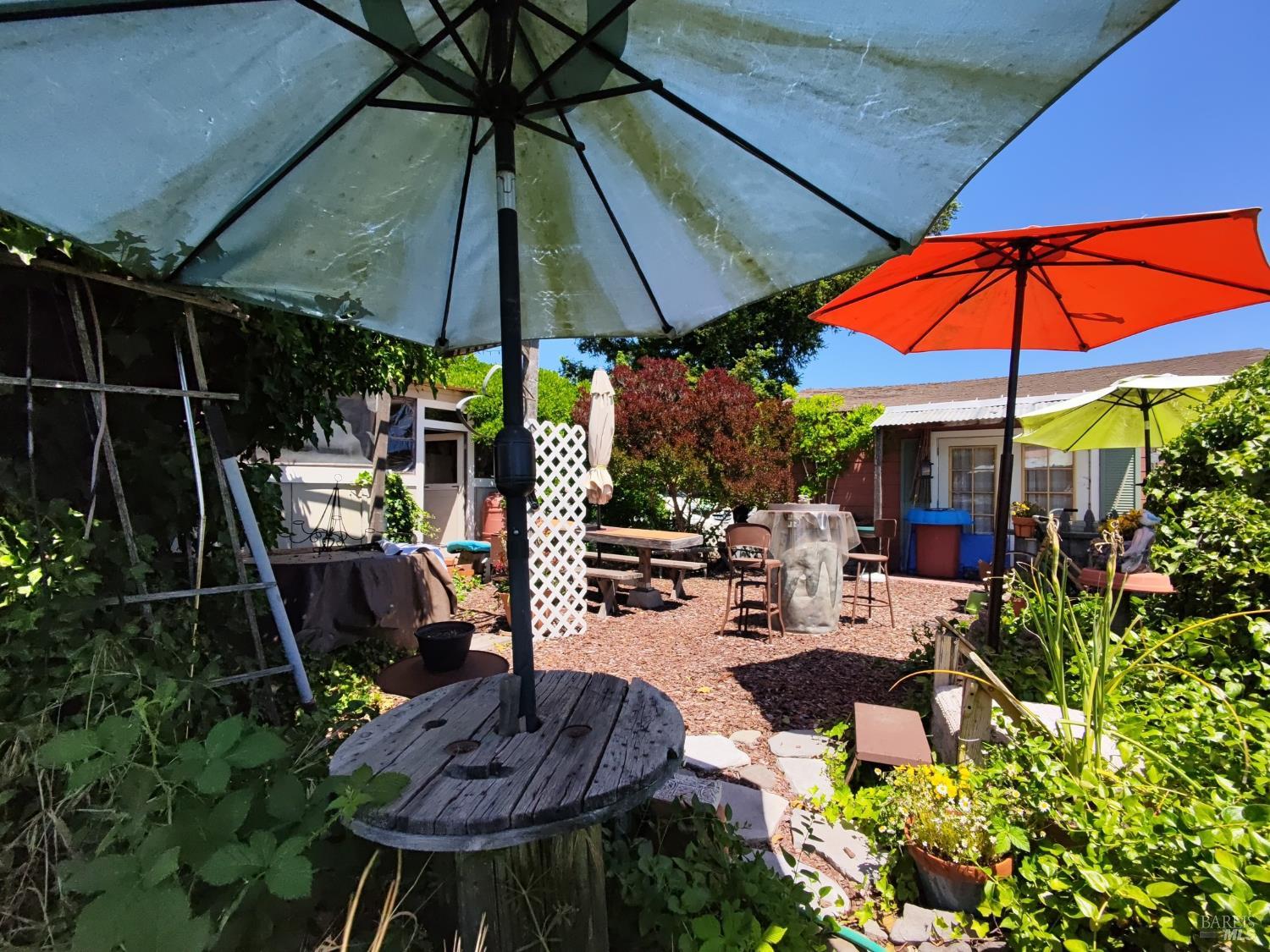148 Millbrae Avenue Santa Rosa, CA 95407 - Photo 28 of 29 a view of patio with chairs and table under an umbrella