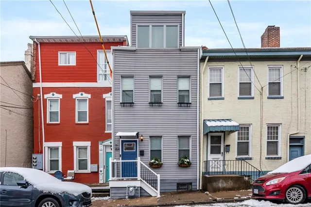 a front view of a house with parking space