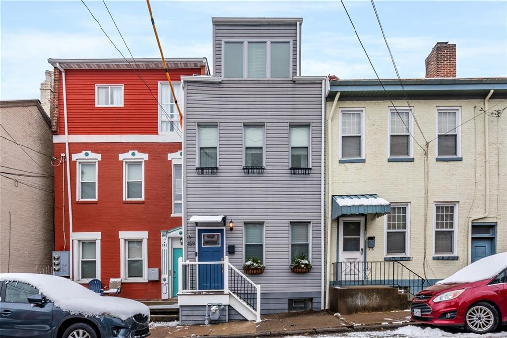 a front view of a house with parking space