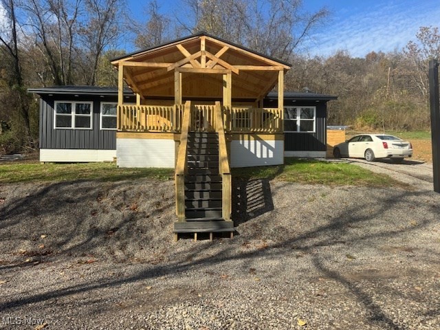 2445 McCord Hill Road Wellsburg, WV 26070 - Photo 1 of 37 View of front of home featuring covered porch, stairway, and board and batten siding