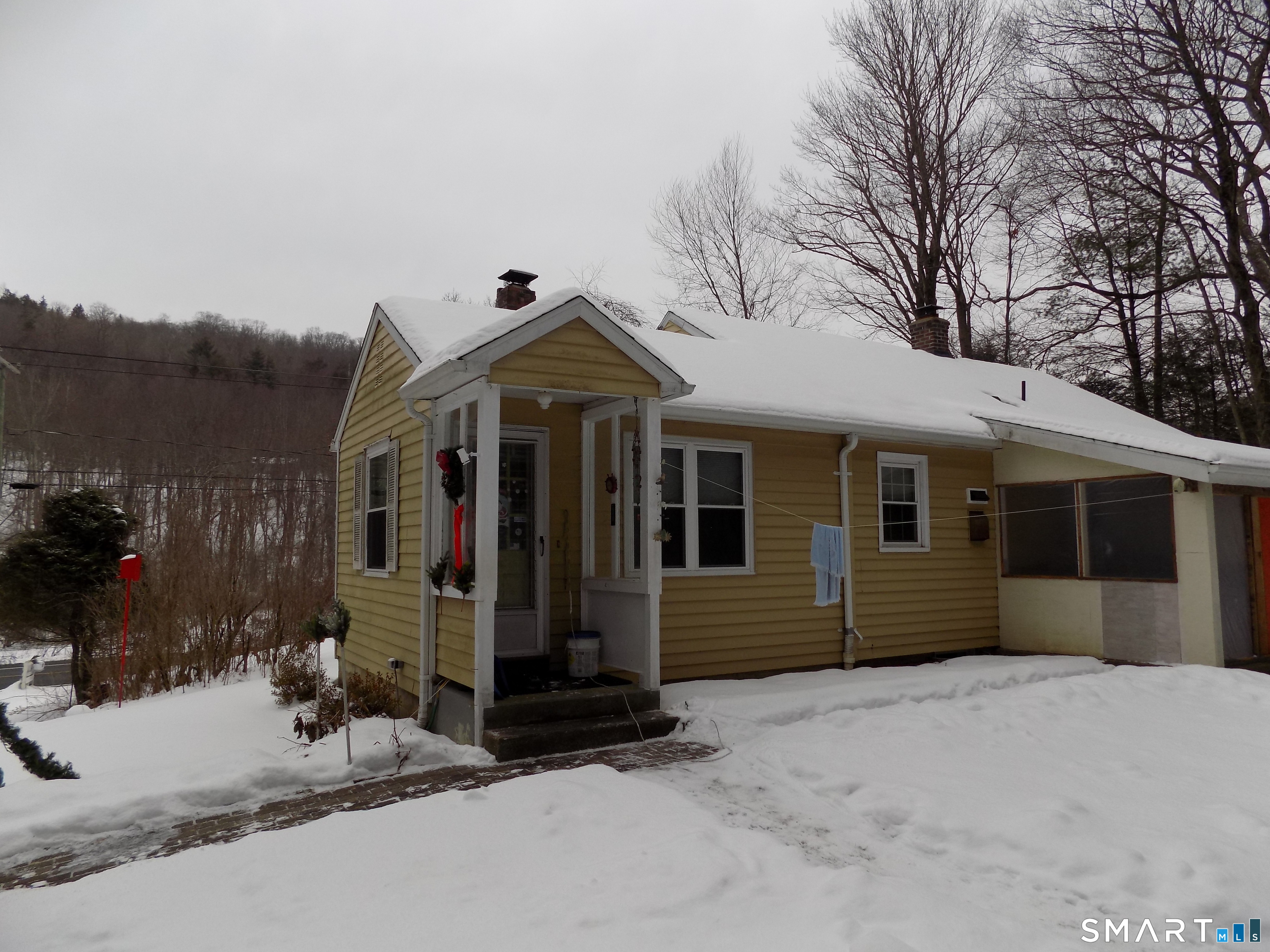 309 New Hartford Road Barkhamsted, CT 06063 - Photo 3 of 16 a front view of a house with a yard and garage