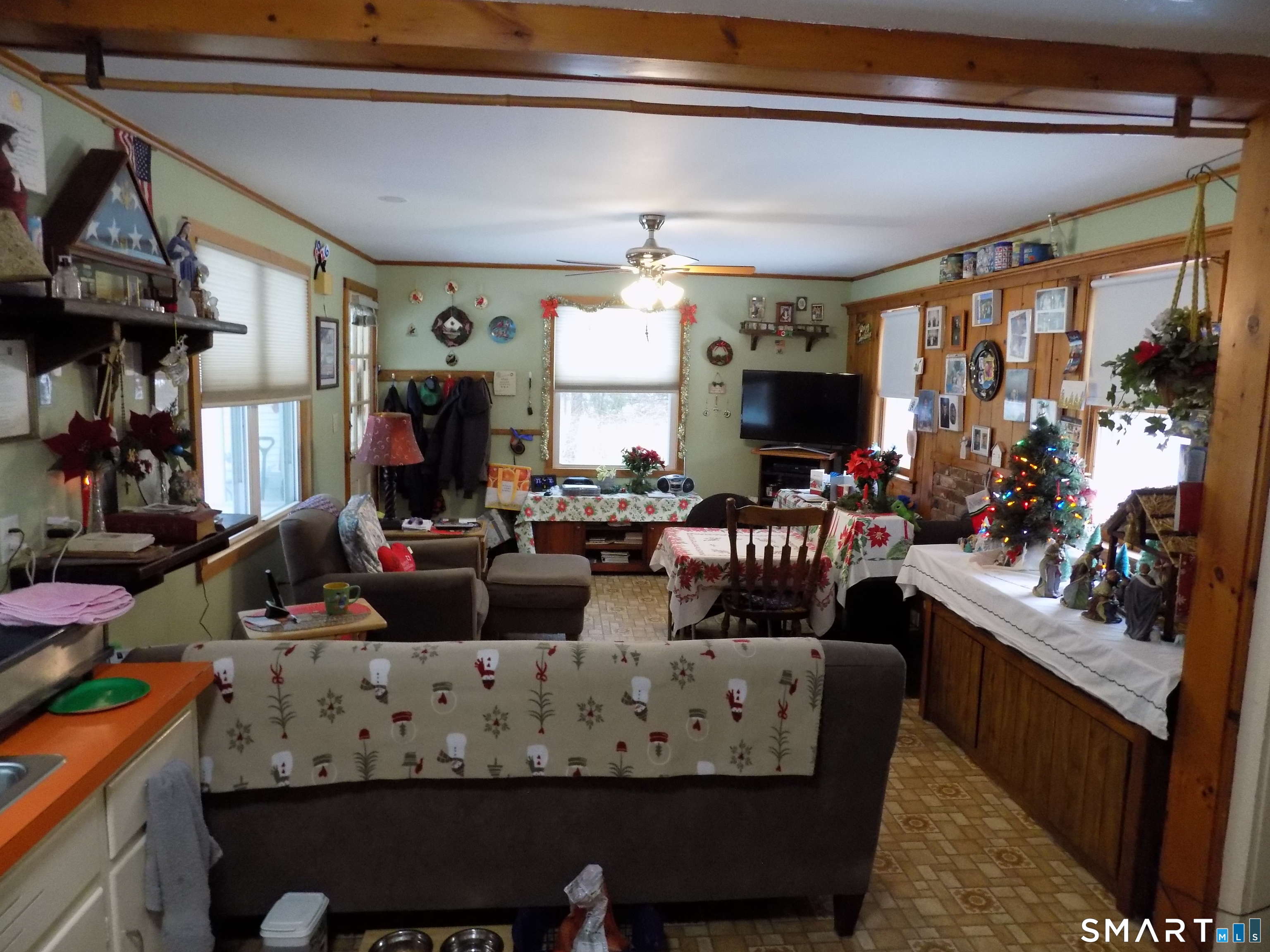 309 New Hartford Road Barkhamsted, CT 06063 - Photo 5 of 16 a living room with furniture a flat screen tv and a large window