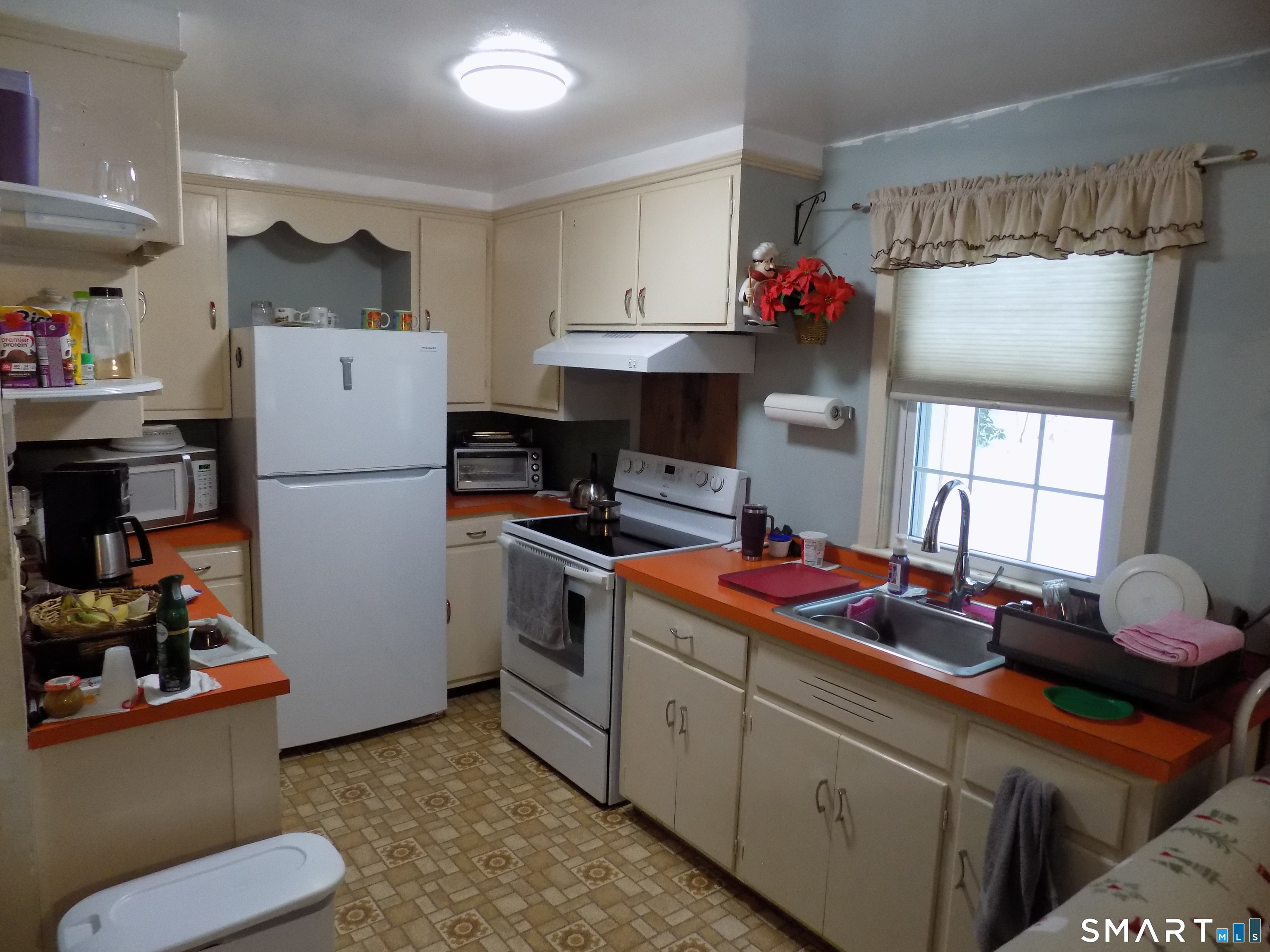 309 New Hartford Road Barkhamsted, CT 06063 - Photo 6 of 16 a kitchen with a refrigerator and white cabinets