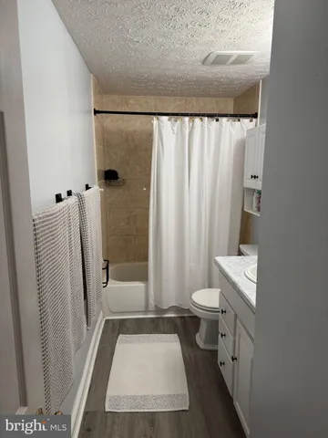 a bathroom with a toilet a sink and a shower