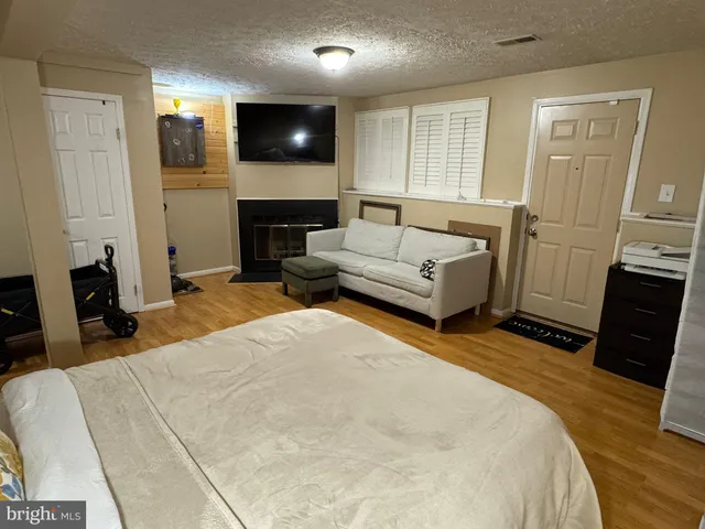 a bedroom with a bed a flat screen tv and a couch