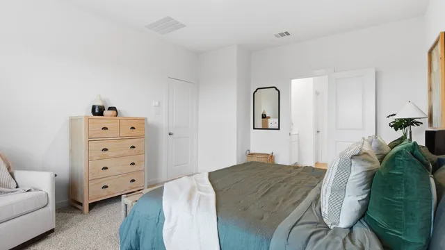 a bedroom with a bed and a dresser