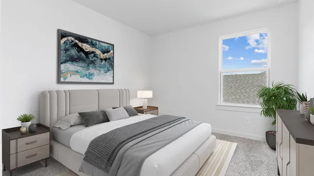 a bedroom with bed and a potted plant