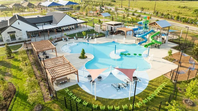 an aerial view of a house outdoor space and swimming pool