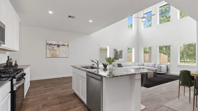 a room with sink cabinets and wooden floor