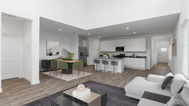 a living room with furniture and view of kitchen