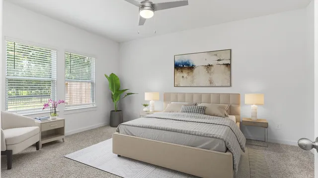 a bedroom with a bed a couch and a window