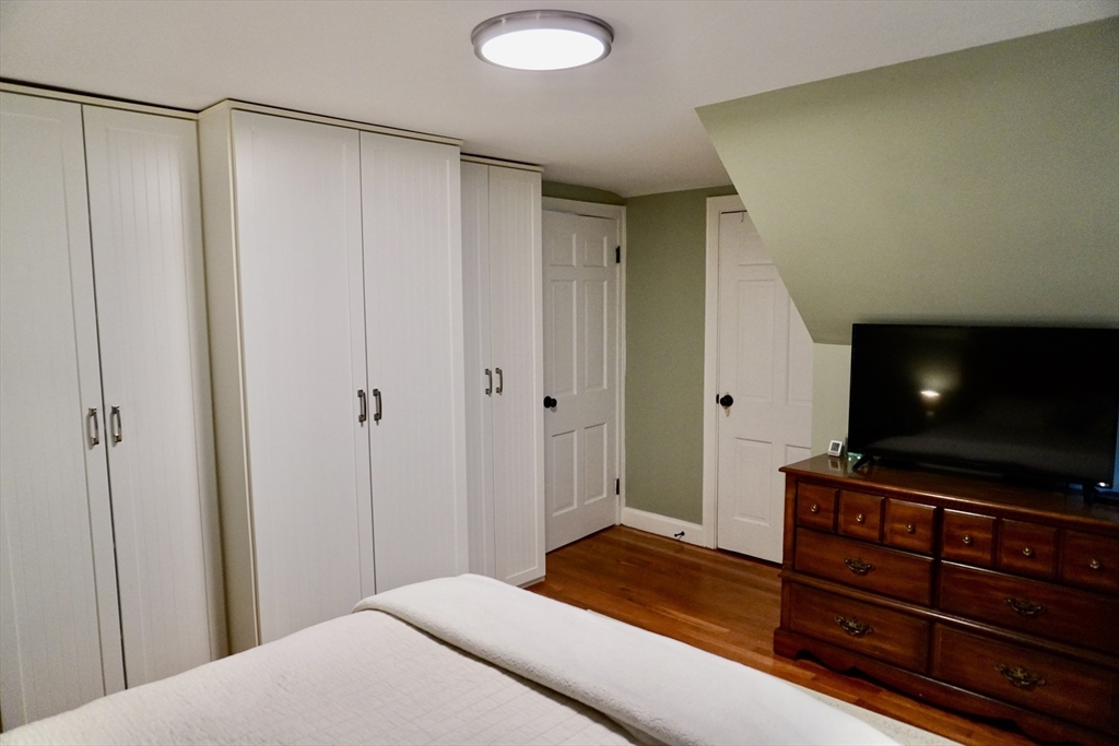 29 Pilgrim Road Weymouth, MA 02191 - Photo 26 of 38 a bedroom with a bed and a flat screen tv