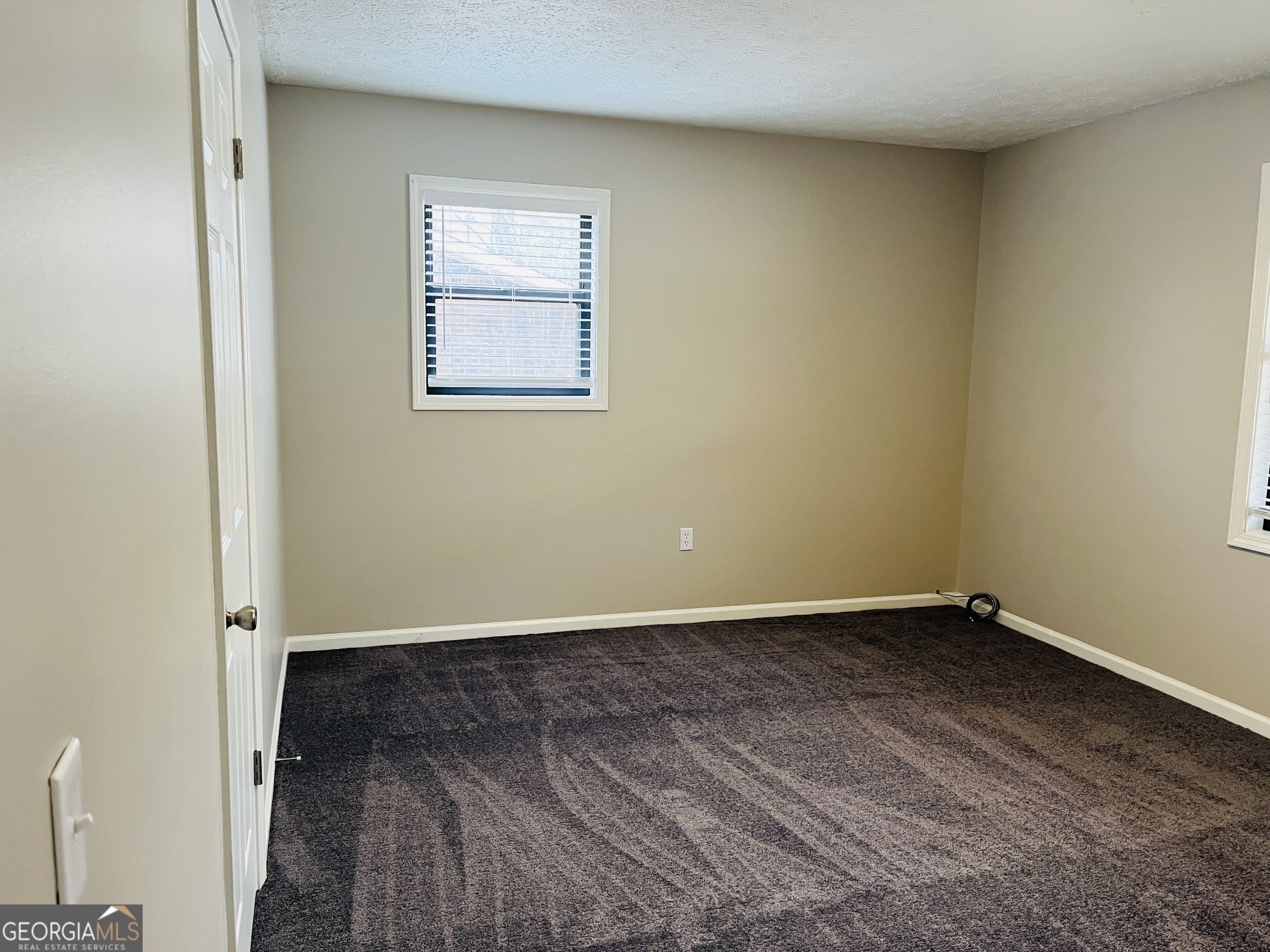 1075 Eastview Road Northeast, Unit A Conyers, GA 30012 - Photo 11 of 21 an empty room with a window