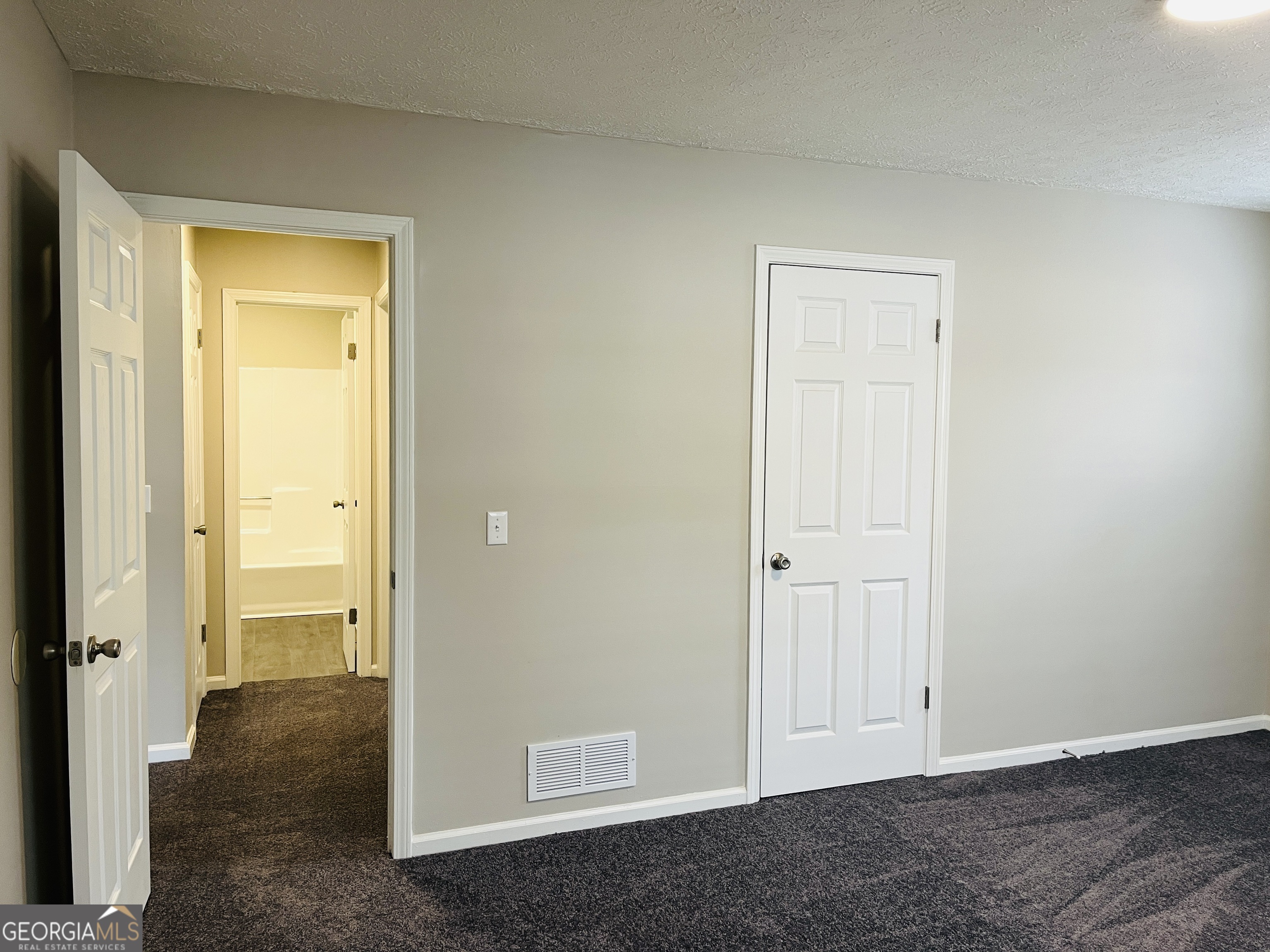 1075 Eastview Road Northeast, Unit A Conyers, GA 30012 - Photo 12 of 21 an empty room that has a wooden cupboard