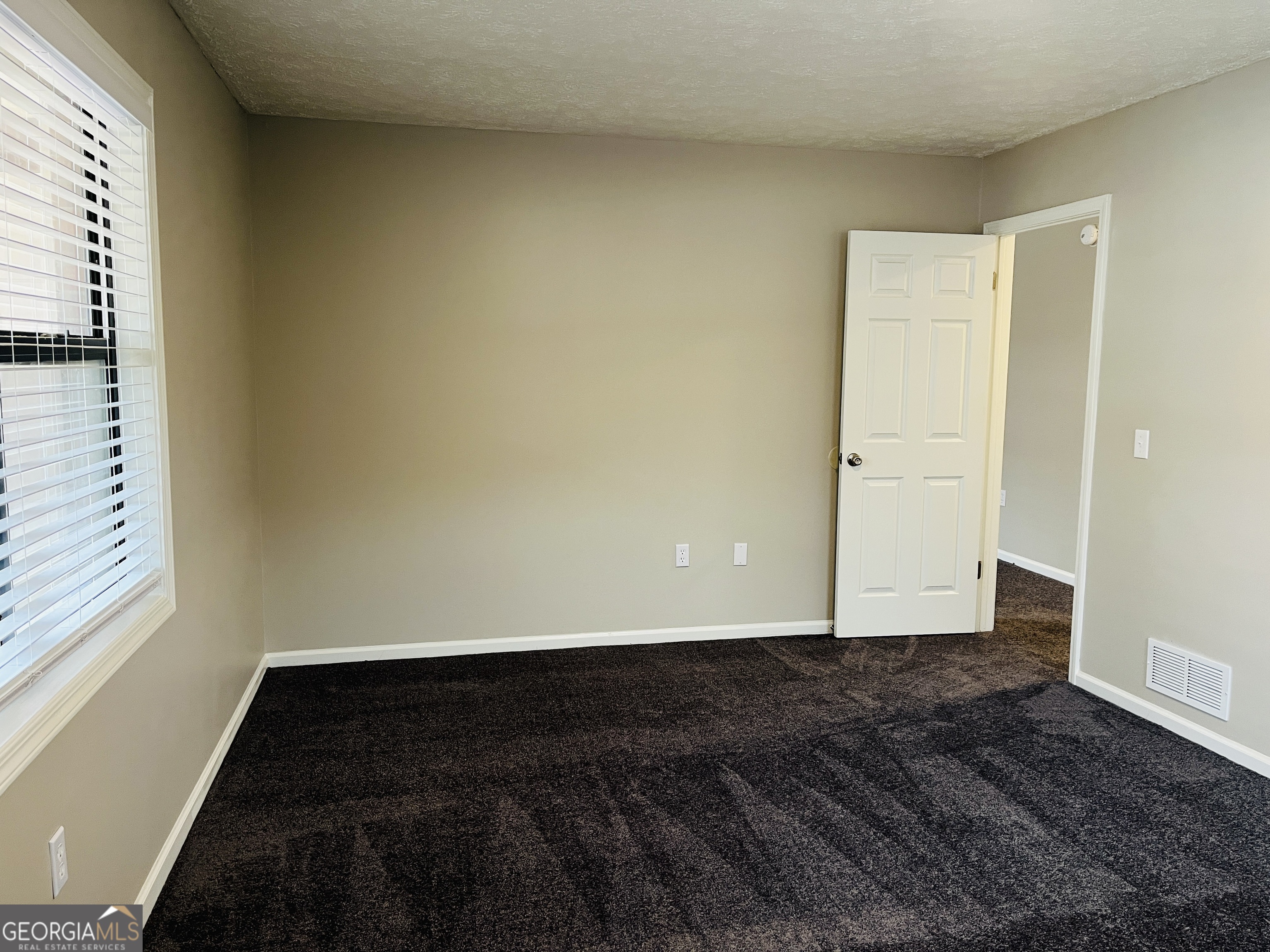 1075 Eastview Road Northeast, Unit A Conyers, GA 30012 - Photo 13 of 21 a view of an empty room and window